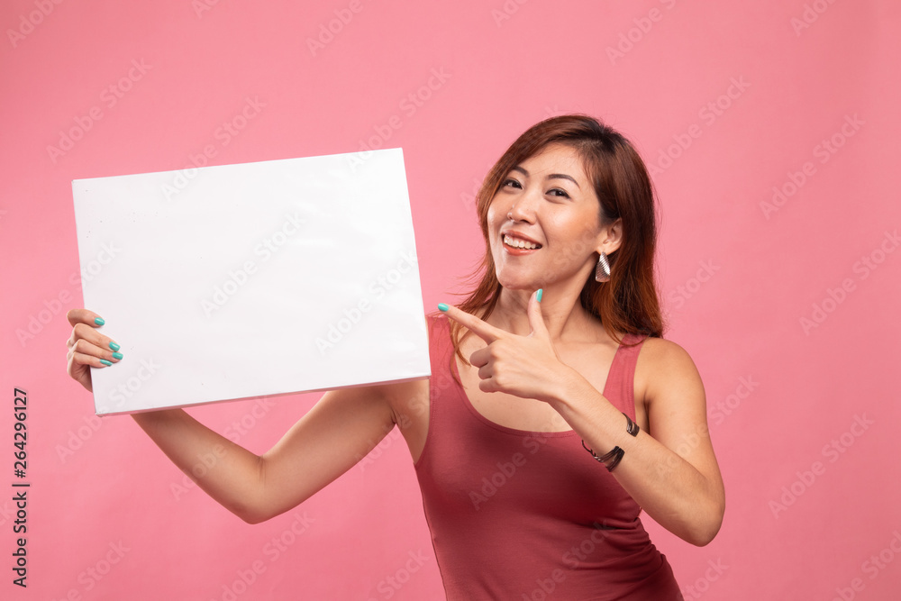 Young Asian woman point to blank sign. Young Asian woman point to blank sign.