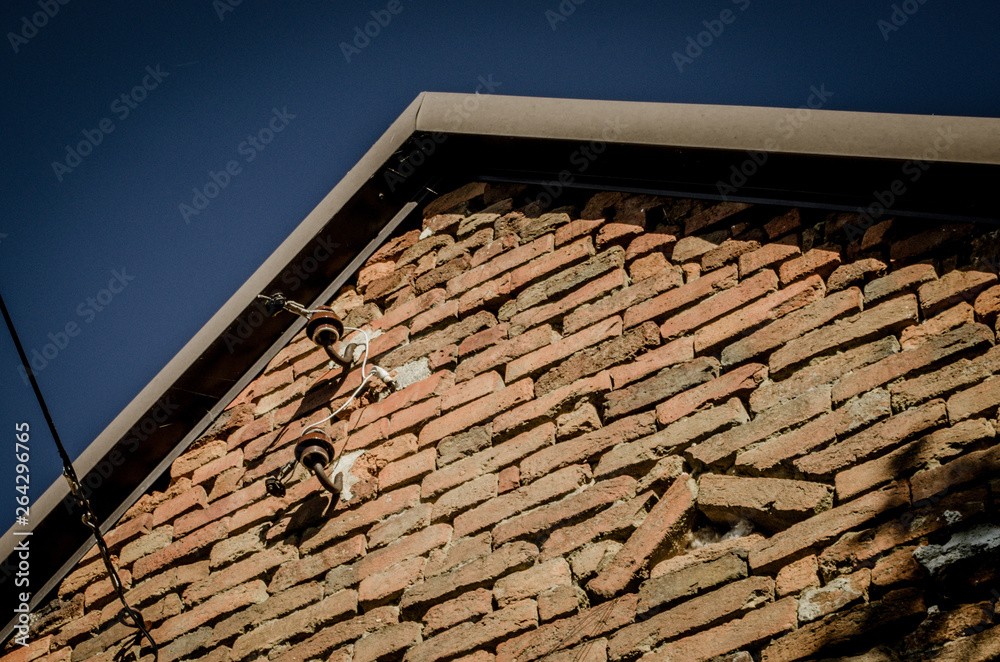 Old ceramic powerline insulators on a wall Old ceramic powerline insulators on a wall