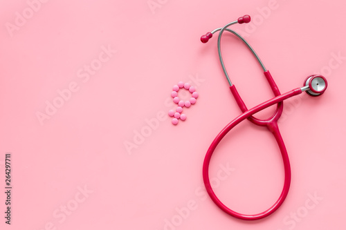 diagnostic and cure of gynaecological disease with stethoscope and female symbol on pink background top view mock-up