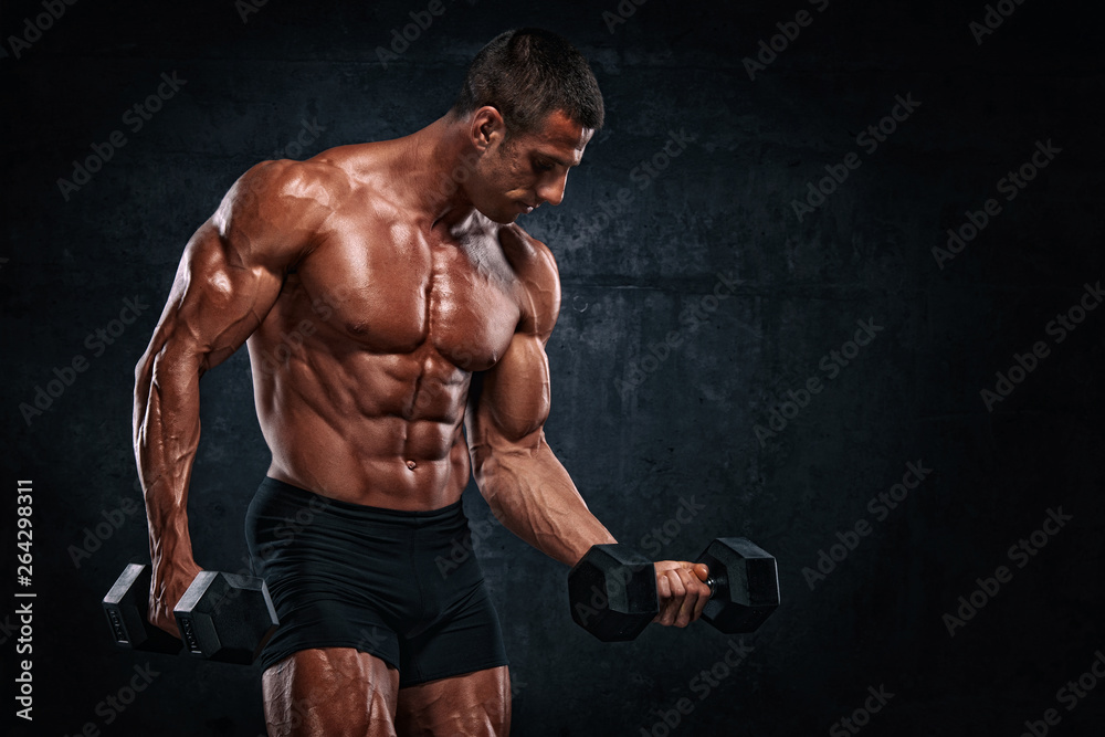 Bodybuilder Exercise With Dumbbells. Performing Dumbbell Curls for biceps