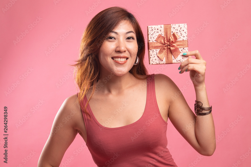 Young Asian woman with a gift box. Young Asian woman with a gift box.