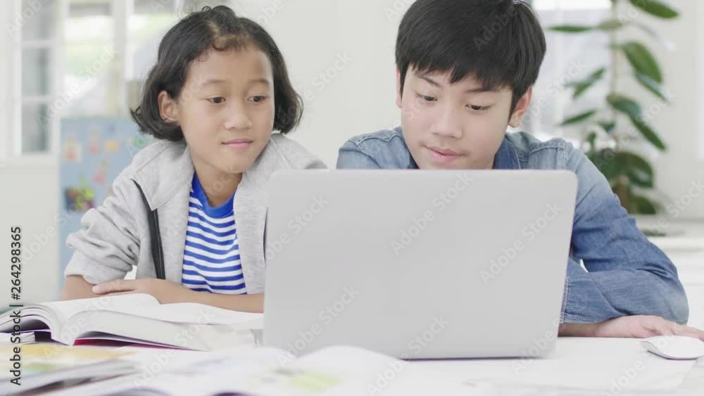 Young boys are using computers to teach and explain homework. To friends with facial expressions and happy gestures, Dolly shot 60fps.