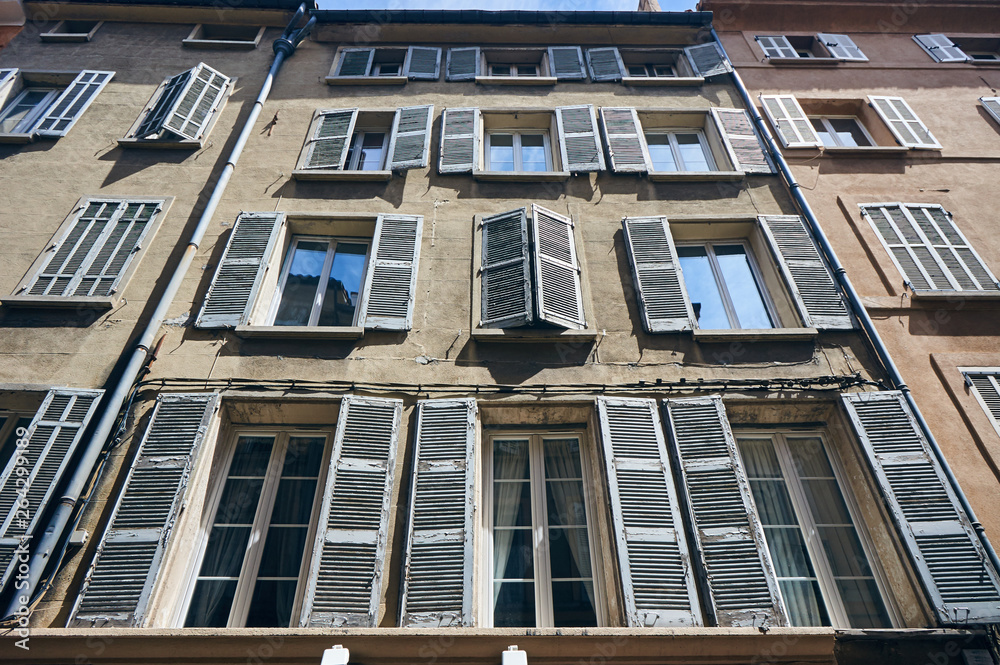 Shutters on the windows of townhouses in the city of Aix-en-Provence in France.. Shutters on the windows of townhouses in the city of Aix-en-Provence in France..