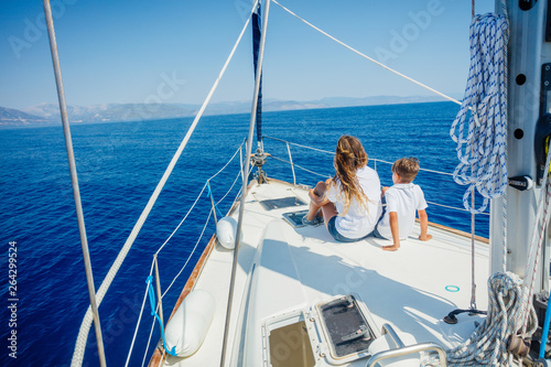 Boy with his sister on board of sailing yacht on summer cruise. © Max Topchii