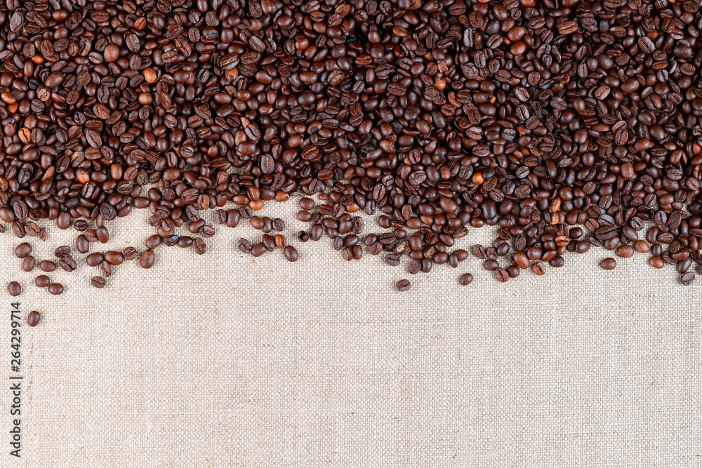 Roasted coffee beans on linea canvas with space on the bottom. Roasted coffee beans on linea canvas with space on the bottom.