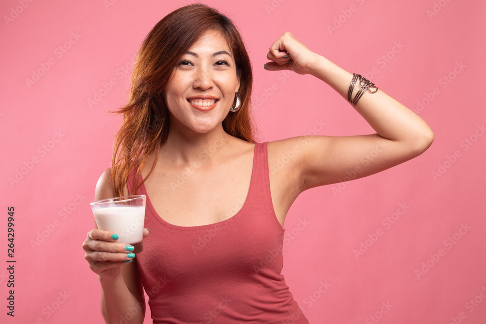 Healthy Asian woman drinking a glass of milk. Healthy Asian woman drinking a glass of milk.