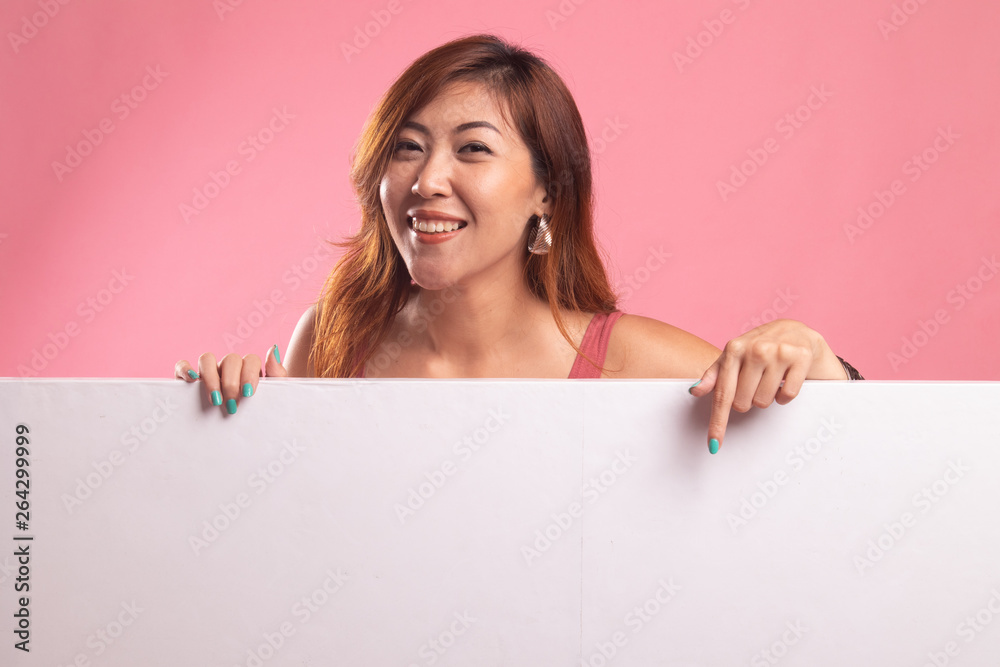 Young Asian woman point to a blank sign. Young Asian woman point to a blank sign.