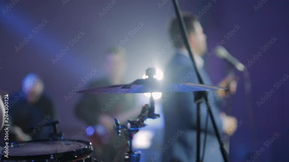 Drummer playing on the drums. Musician plays a musical instrument on the concert stage