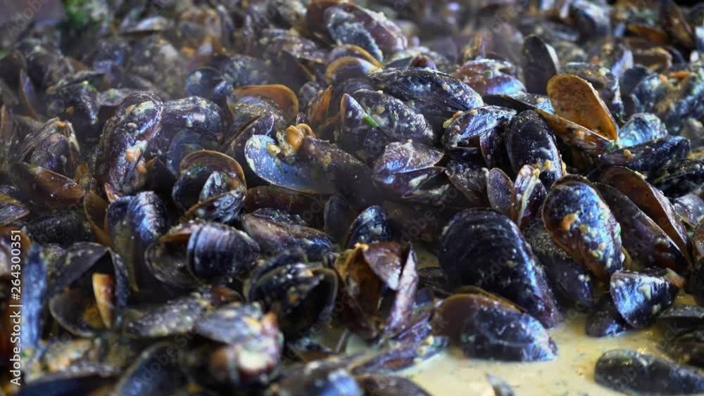 Fries Shell Mussels in the shell. Cook fries mussels in a large frying pan. Seafood ...