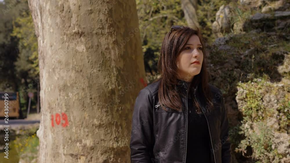 young pretty woman Waiting For Someone In A Park On A Sunny Day young pretty woman Waiting For Someone In A Park On A Sunny Day