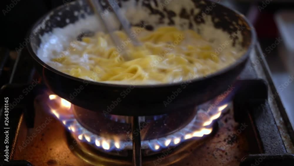 Pasta. Chef prepares pasta with cheese in a pan. Street restaurant. Spaghetti cheese sauce. Pasta. Chef prepares pasta with cheese in a pan. Street restaurant. Spaghetti cheese sauce.