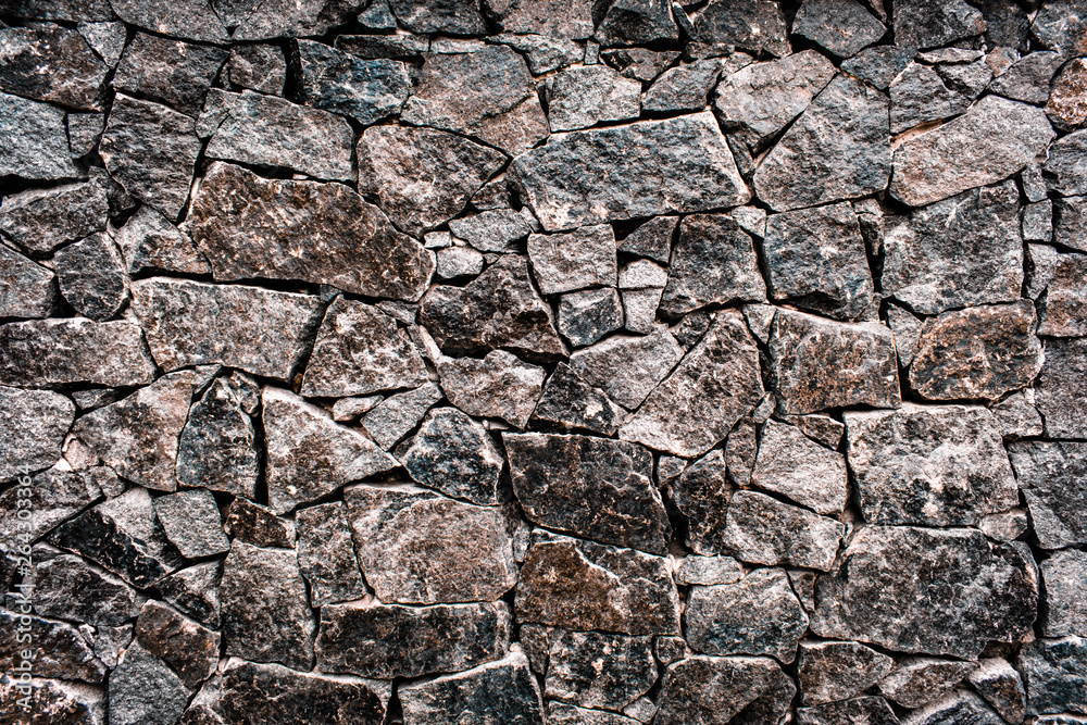 Textured texture of an old stone wall. Wallpaper for background and design Textured texture of an old stone wall. Wallpaper for background and design