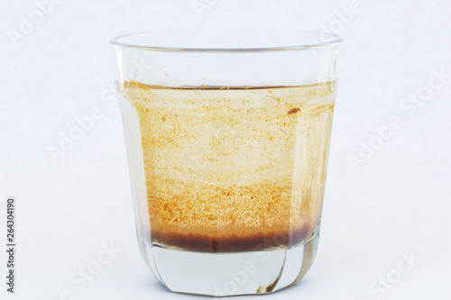 Contaminated water in a glass