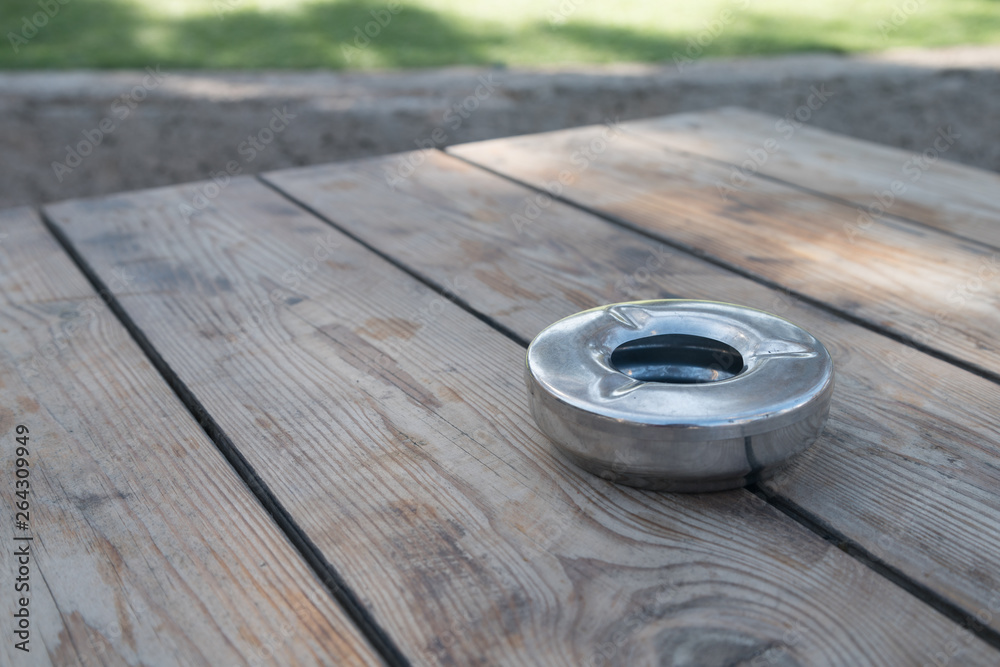 View of Park Table with Metal Ashtray in a Sunny Day View of Park Table with Metal Ashtray in a Sunny Day