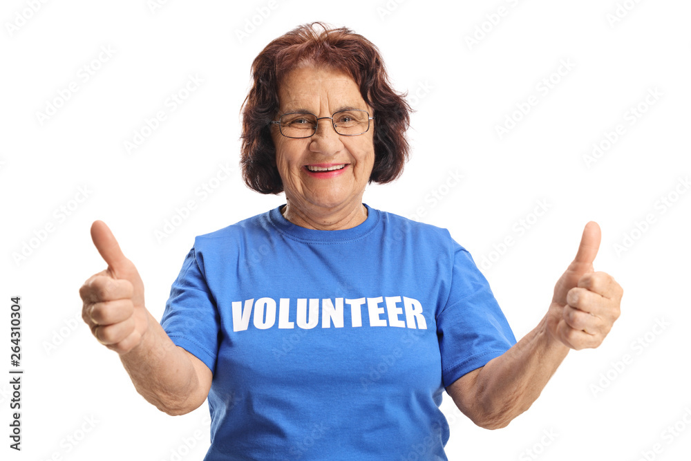 Cheerful elderly female volunteer showing thumbs up Cheerful elderly female volunteer showing thumbs up