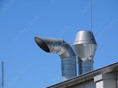 Tableau sur toile Fresh air intake / exhaust chimneys of a ventilation system on top of a roof aga