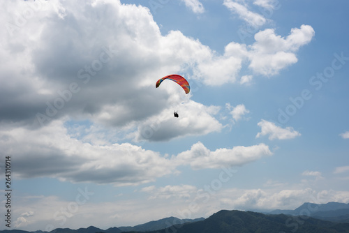 colorful paragliding under blue sky