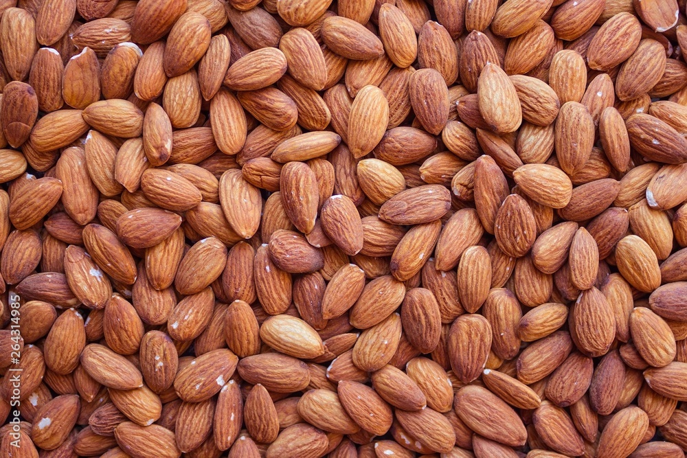 Peeled almonds, a natural source of vegetable protein and vitamins. Vegetarian menu, fasting, diet. Top view, daylight. Peeled almonds, a natural source of vegetable protein and vitamins. Vegetarian menu, fasting, diet. Top view, daylight.