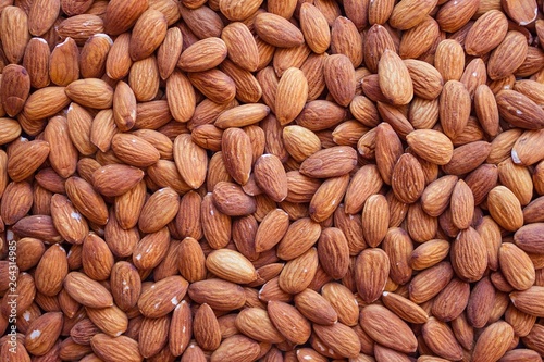 Peeled almonds, a natural source of vegetable protein and vitamins. Vegetarian menu, fasting, diet. Top view, daylight.