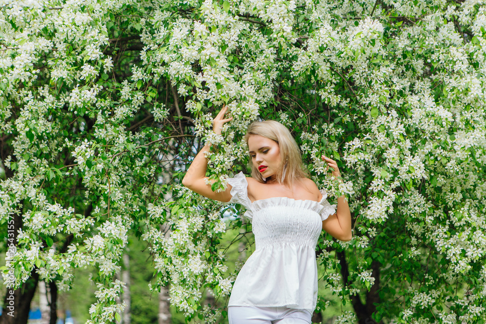 Sexy modern bride enjoing blooming apple tree flowers. Sexy modern bride enjoing blooming apple tree flowers.