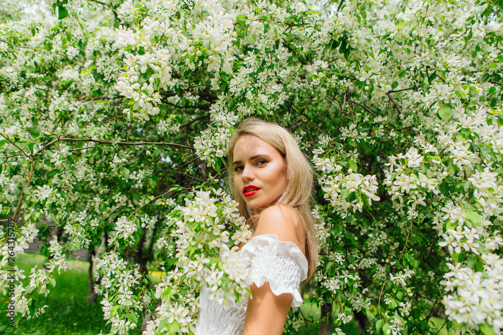 Sexy modern bride enjoing blooming apple tree flowers. Sexy modern bride enjoing blooming apple tree flowers.