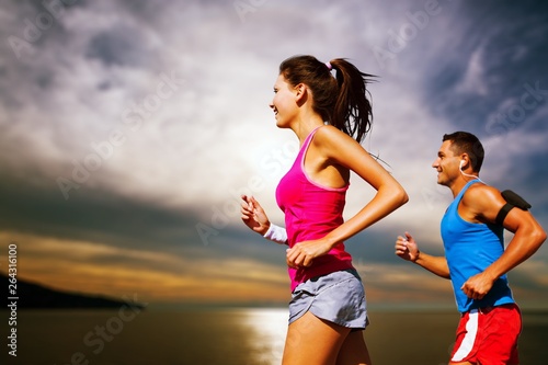 Fitness  sport  friendship and lifestyle concept - smiling couple  running together