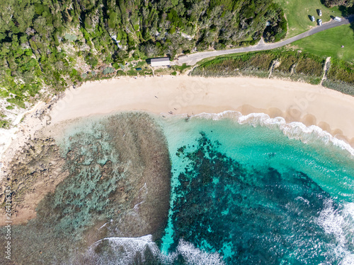 Stunning aerial drone view of Ned's Beach on Lord Howe Island in the Tasman Sea. Beautiful white sand beach, turquoise water, waves and corals. Lord Howe belongs to New South Wales, Australia.