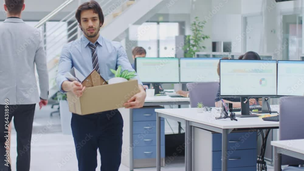 Sad Fired / Let Go Office Worker Packs His Belongings into Cardboard Box and Leaves Office. Workforce Reduction, Downsizing, Reorganization, Restructuring, Outsourcing. Mass Unemployment Market Crisis Sad Fired / Let Go Office Worker Packs His Belongings into Cardboard Box and Leaves Office. Workforce Reduction, Downsizing, Reorganization, Restructuring, Outsourcing. Mass Unemployment Market Crisis