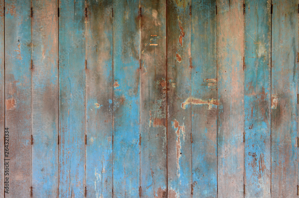 Old and dirty blue wooden door. Wooden door background texture. Wall and door decoration and design.