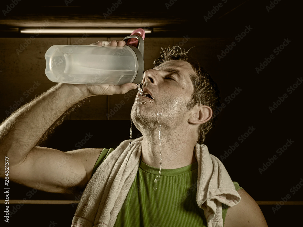 Sweaty after great work out. Handsome young men in sportswear whipping  sweat with his towel and holding water bottle while sitting at gym 13487667  Stock Photo at Vecteezy