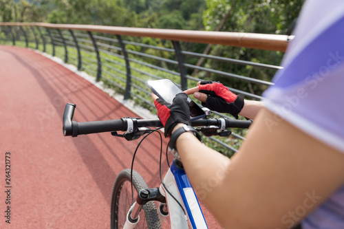 use smart phone app for navigation while bike ride on the forest trail © lzf