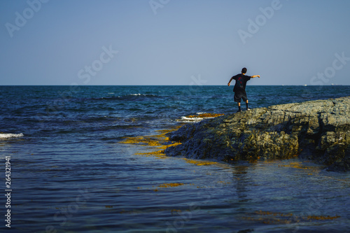 ocean boy skipping stones