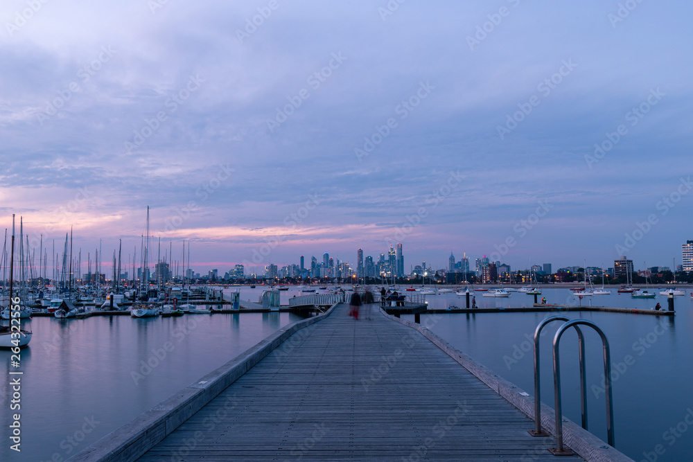 Melbourne skyline, pier, and boats view at dusk time.