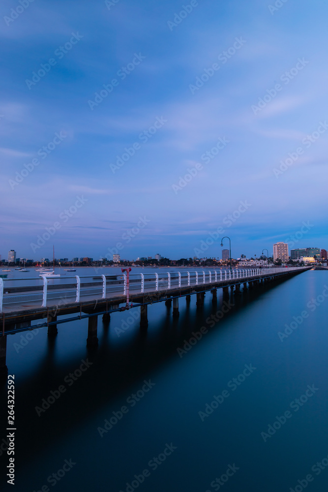 View of St Kilda pier at dusk towards the beach.