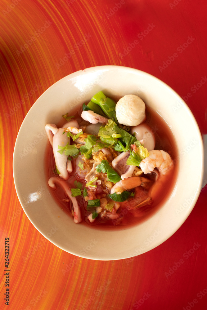 pink seafood flat rice noodles soup on table background,Thai food yen ta fo pink seafood flat rice noodles soup on table background,Thai food yen ta fo