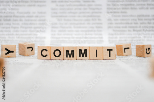 Commit word Written In Wooden Cube - Newspaper photo