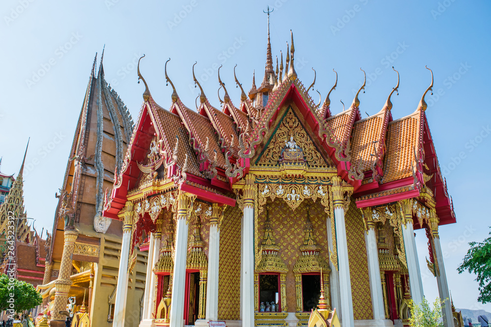 Architecture golden church with big buddha and pagoda in Wat Tham Sua