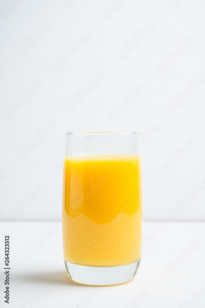 Fresh squeezed orange juice on the rustic background. Selective focus. Shallow depth of field. Fresh squeezed orange juice on the rustic background. Selective focus. Shallow depth of field.