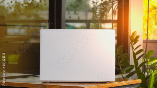 White notebook Placed on a wooden table in the morning, lifestyle concept