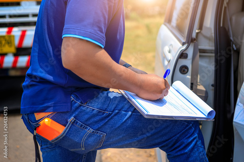 Employers checking drivers for alcohol usage before driving,Truck drivers hand holding clipboard Check the product list,spot focus.