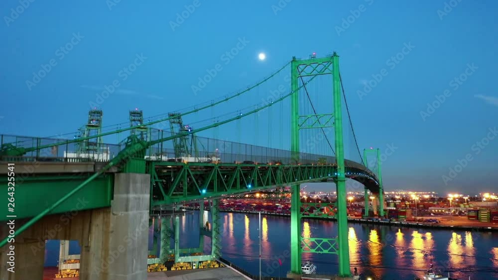 Aerial Ascend: Bright Green Bridge Bustling At Night Over Blue River in Long Beach, United States of America Aerial Ascend: Bright Green Bridge Bustling At Night Over Blue River in Long Beach, United States of America