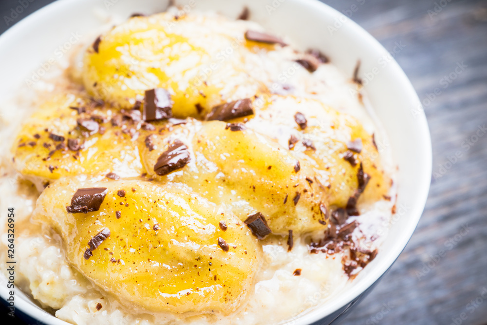 Oatmeal with roasted bananas and chocolate. Selective focus. Shallow depth of field. Oatmeal with roasted bananas and chocolate. Selective focus. Shallow depth of field.