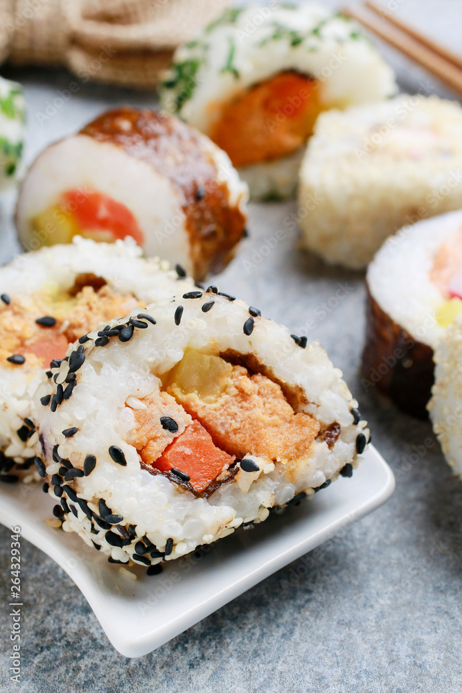 Sushi set on grey stone background.