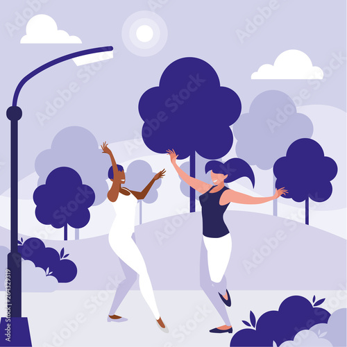 young interracial girls dancing in the park