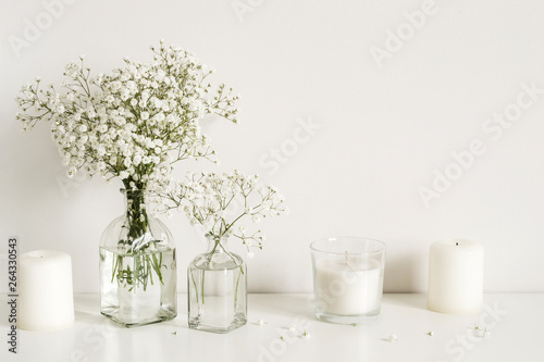 White arrangement of baby s breath flowers and candles. Copy space for lettering