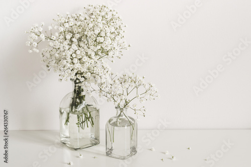 Romantic elegant bouquets gypsophila flowers on table wall background. Copy space for text or lettering photo