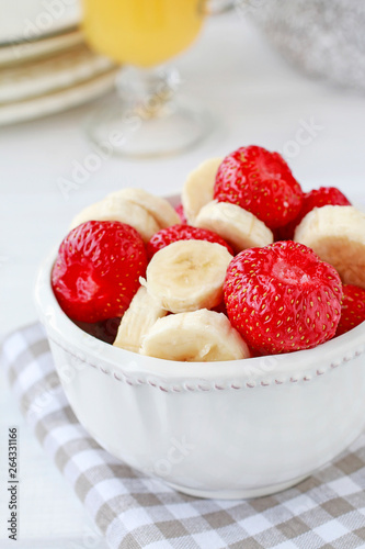 Fruit salad with bananas and strawberries.