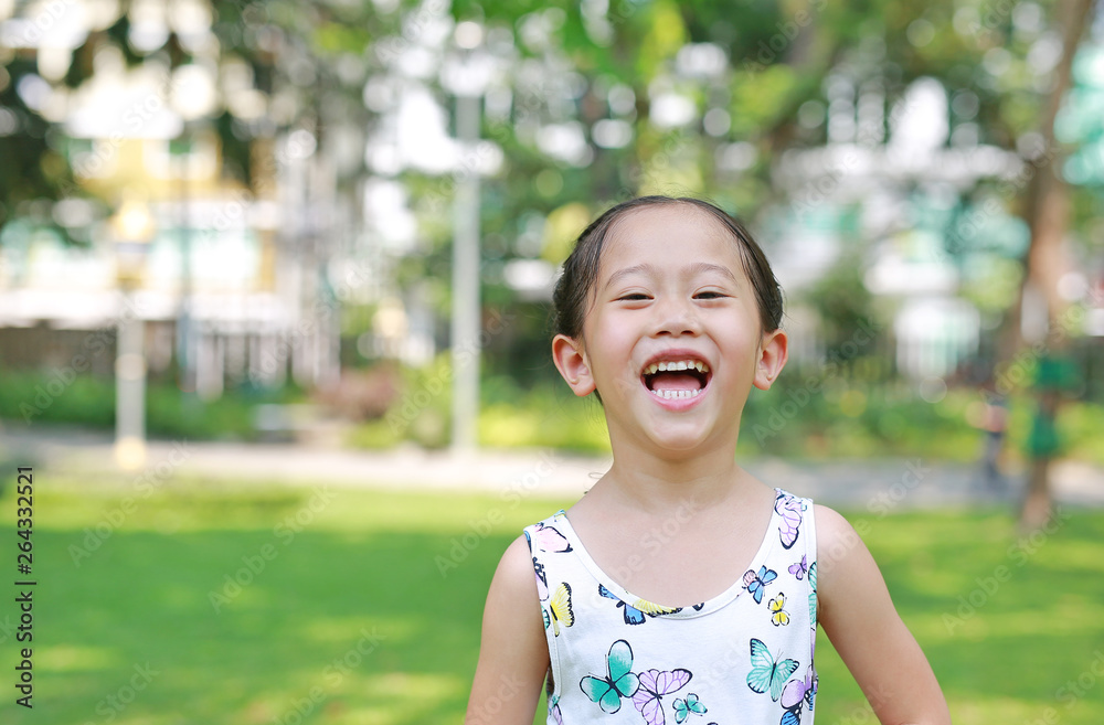 Portrait of happy little Asian child girl in sunny green park. Portrait of happy little Asian child girl in sunny green park.