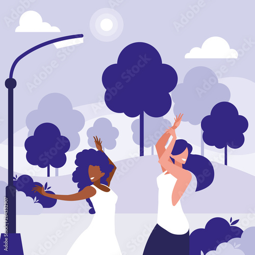young interracial girls dancing in the park