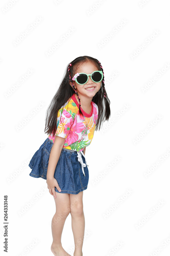 Happy little Asian kid girl wearing a flowers summer dress and sunglasses  isolated on white background. Summer fashion kid concept. Stock Photo
